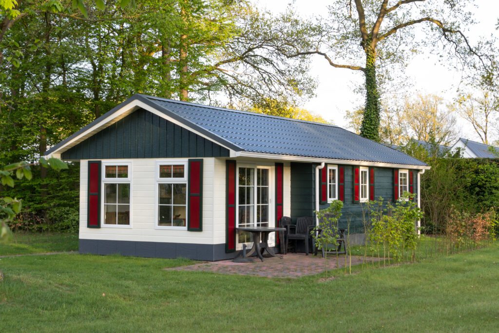 A wooden holiday home with blue colored roofing